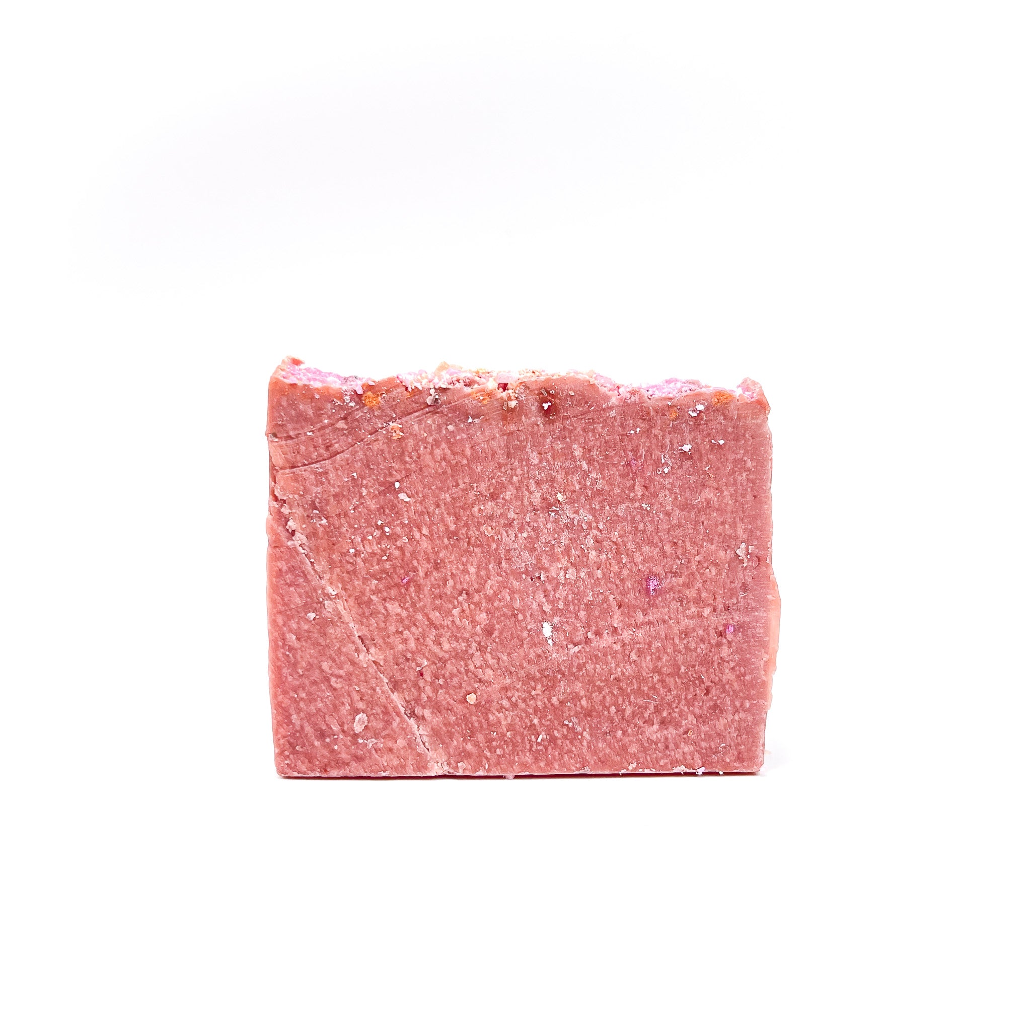 A bar of pink blush colored handmade soap from Rusted Acre Soap Company.