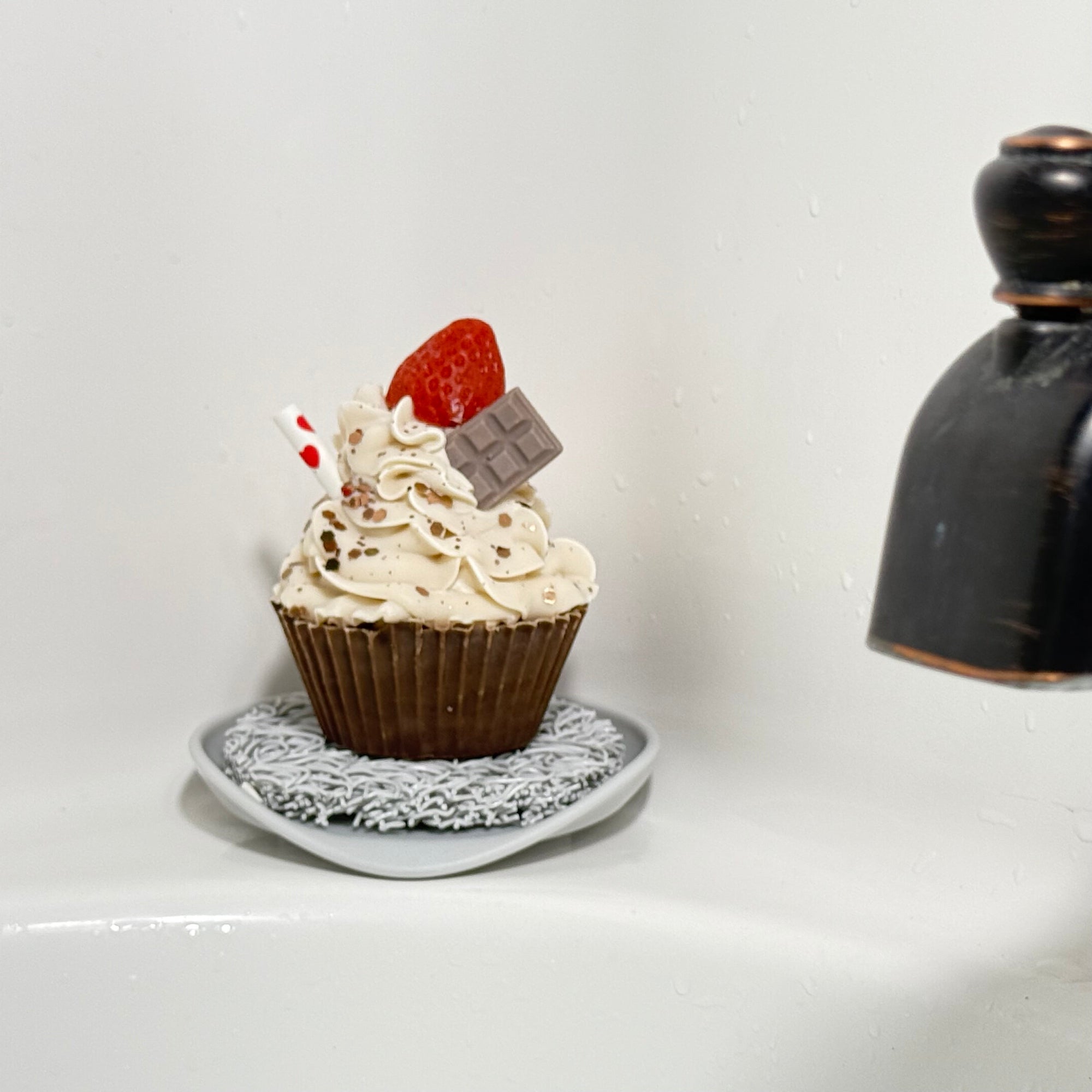 One of Rusted Acre Soap Company's chocolate strawberry cupcake soaps displayed on the side of a tub. Soap lift sold separately.