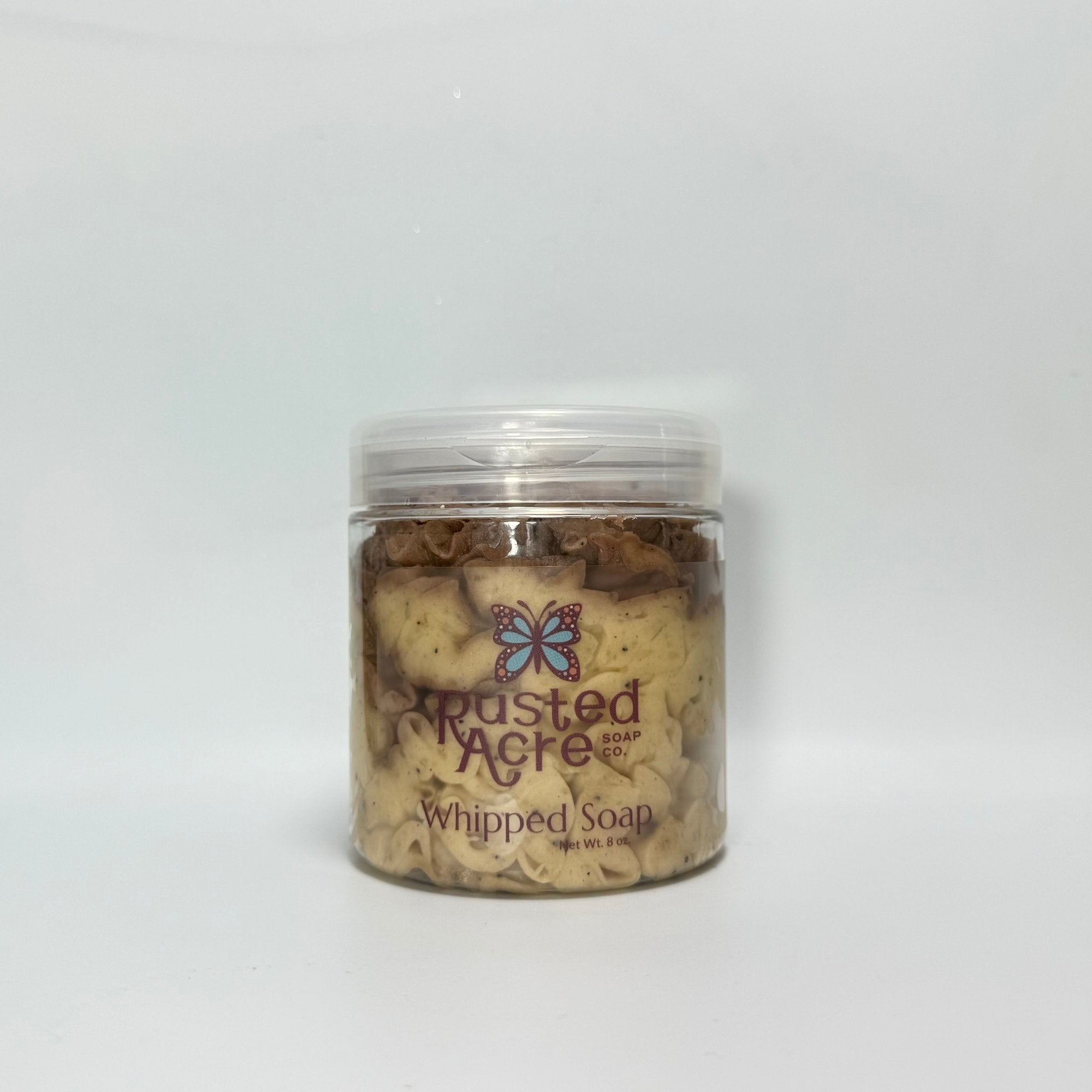 A jar of cream colored whipped soap fro Rusted Acre Soap Co piped nicely into a jar.