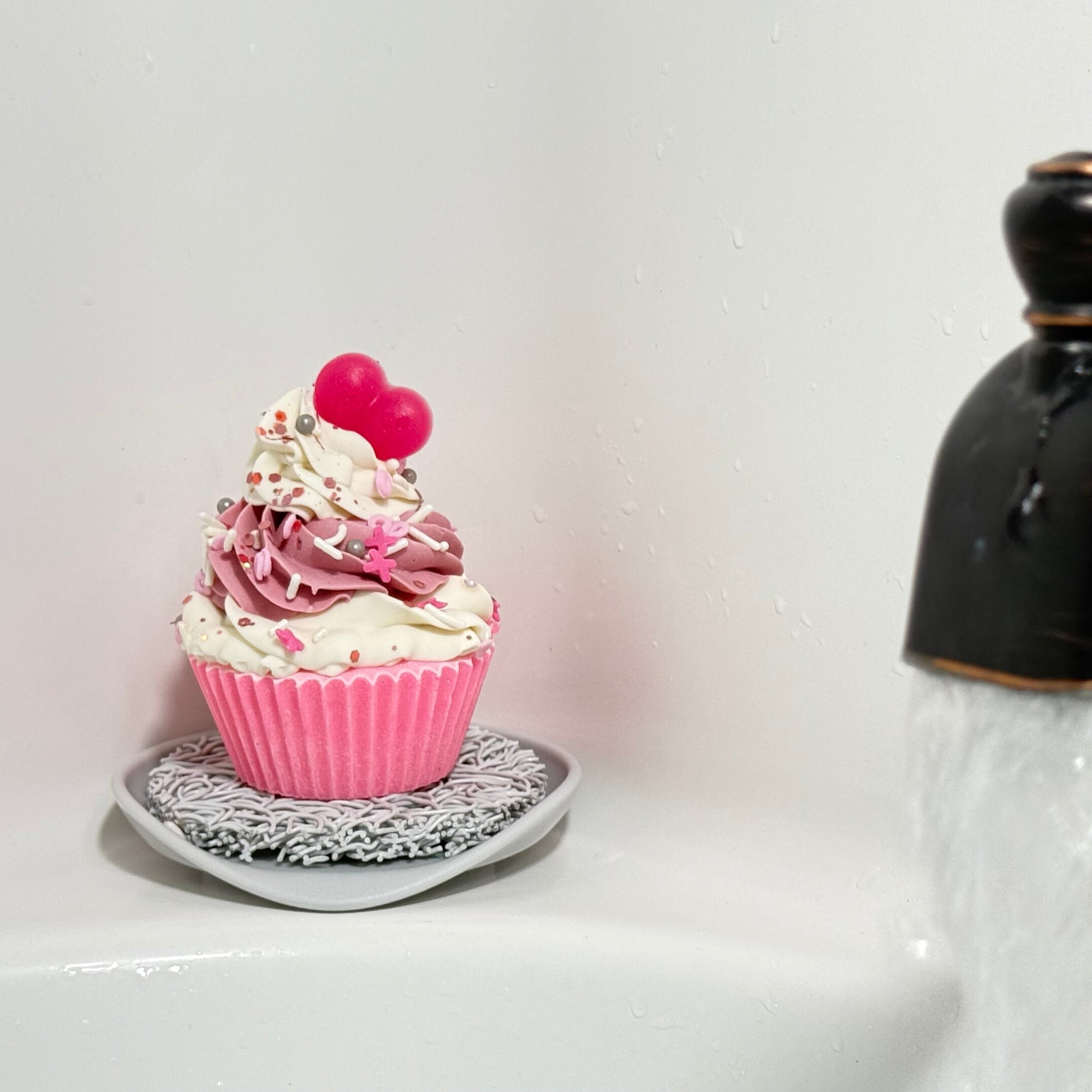 One of Rusted Acre Soap Company's heart cupcake soaps on the side of a tub with a soap lift (sold separately).