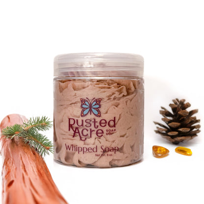 Jar of Rusted Acre Soap Company's vegan Mahogany whipped soap. brown soap in a reusable plastic jar in a lifestyle setting. 