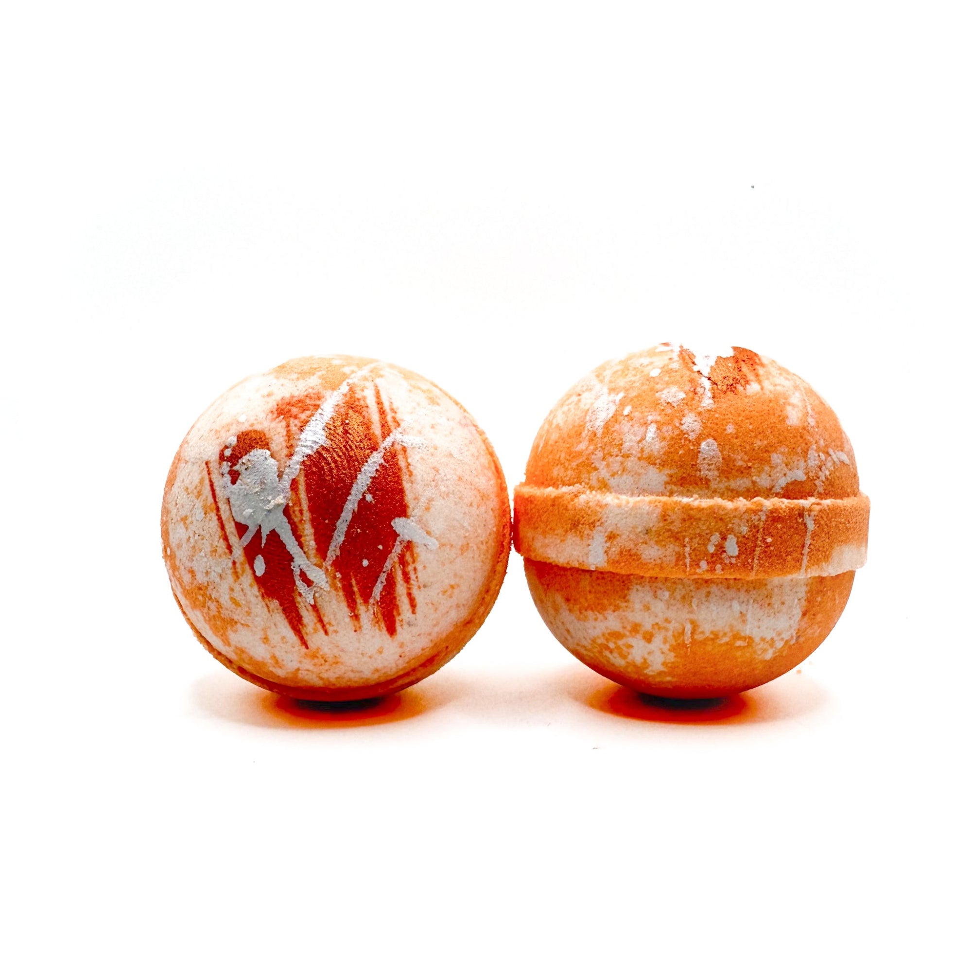 Two round orange dream bath bombs handmade by Rusted Acre Soap Company.