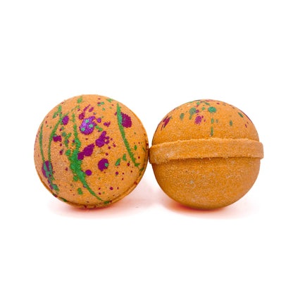 Two bright orange fruity cereal scented round bath bombs. Hand-painted with splatters of bright green and purple. 