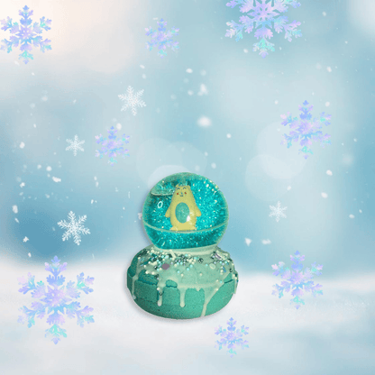 A teal snow globe bath bomb from Rusted Acre Soap Co, topped with an Abominable Snowman bouncy ball.