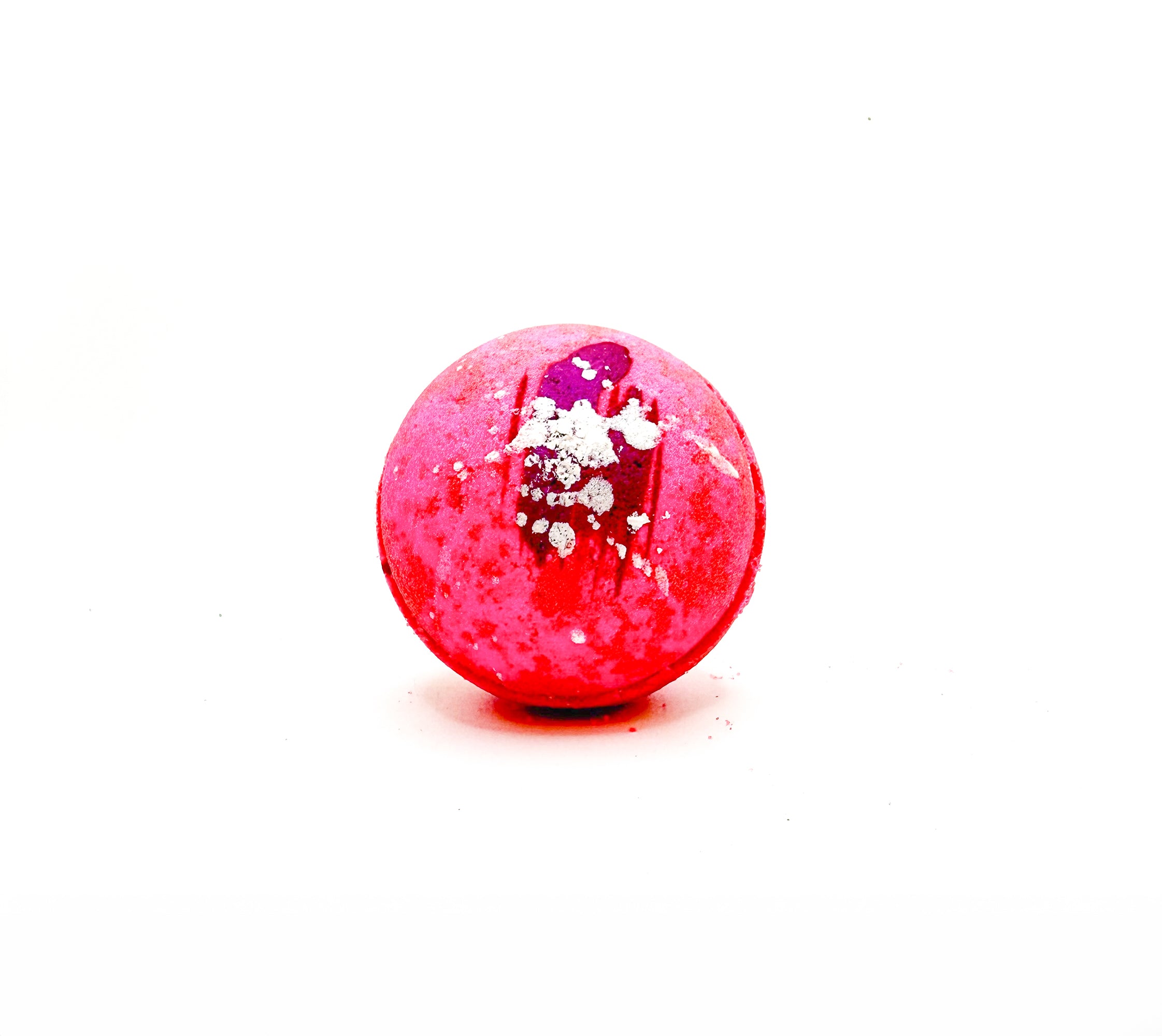 One pink round bath bomb hand-painted with dark pink, and splatted with silver. 